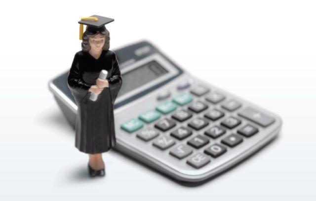 Image of college graduate standing next to a calculator