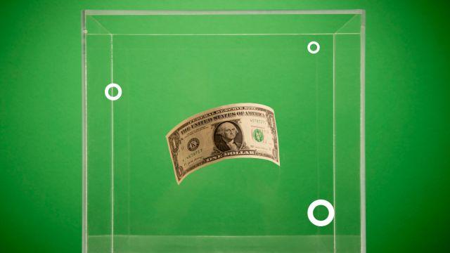 dollar bill against green backdrop