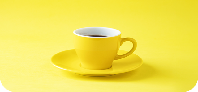 yellow cup of coffee on yellow background